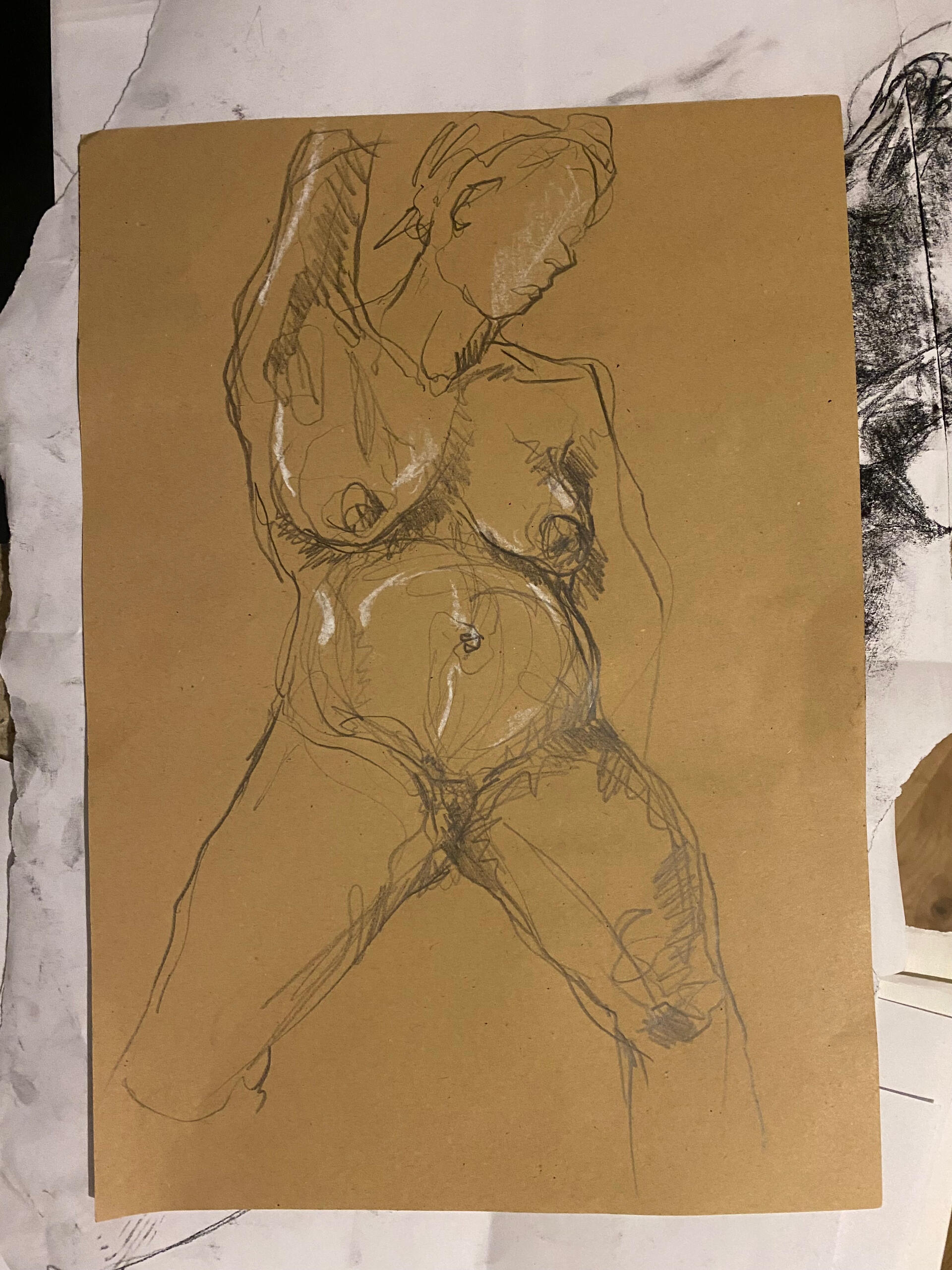 Figure study of Kat’s pregnant body A pencil sketch of a seated pregnant nude figure on brown paper, capturing dynamic lines and shading. The tone is expressive and raw. White highlights add depth.